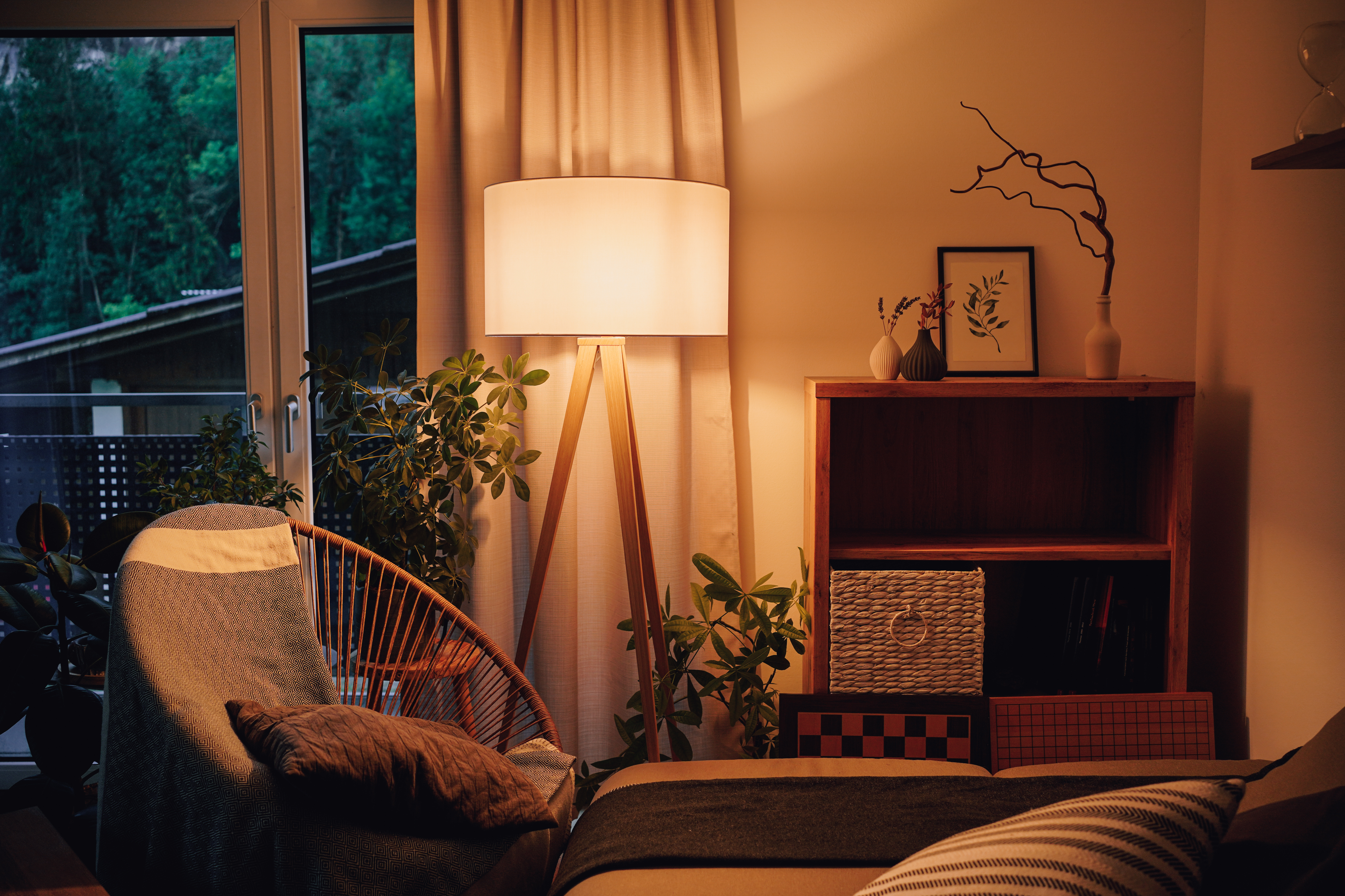 A warmly lit apartment living room in the evening